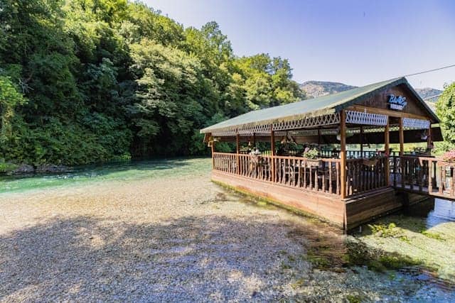 Scenic waterfront outdoor dining near me with tables overlooking the water at sunset
